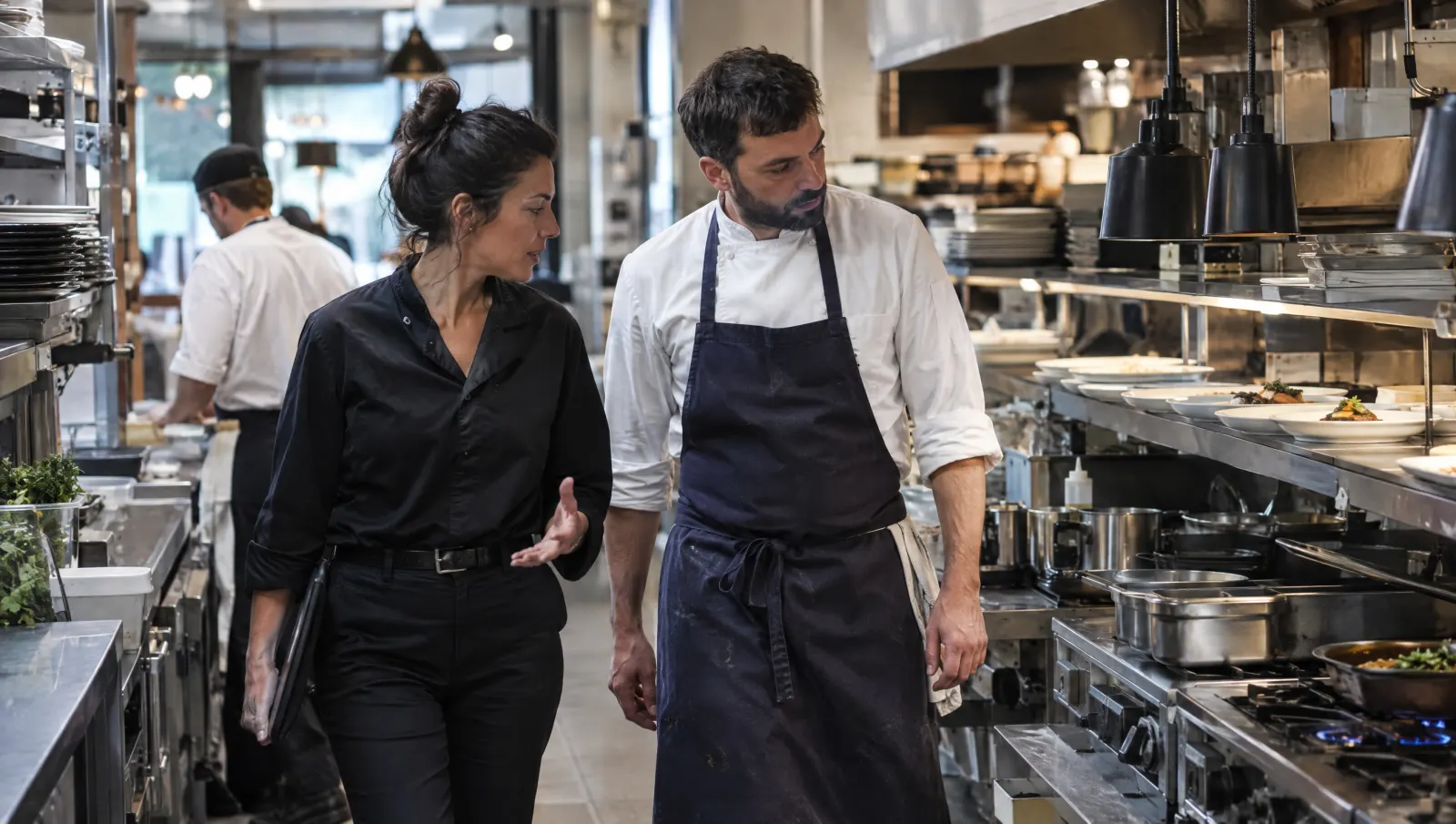 Une superviseure fait le tour de la cuisine avec le chef